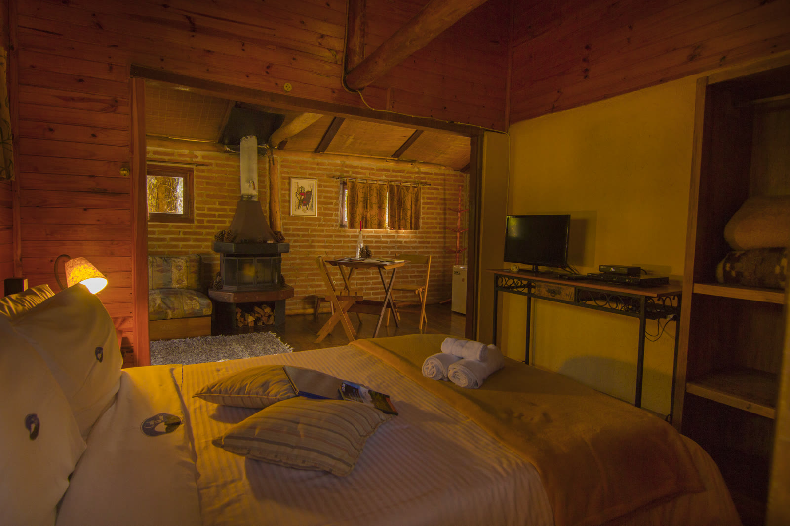 Cama do Paineiras com a sala e a lareira ao fundo